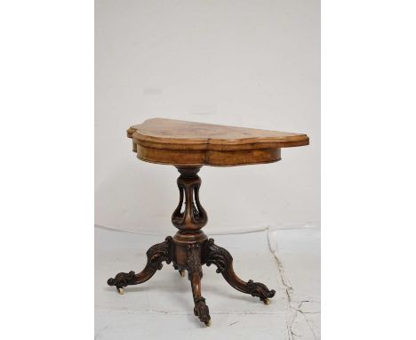 Victorian walnut shaped demi-lune card table, lined in green baize, the carved pedestal raised on four carved downswept suppo