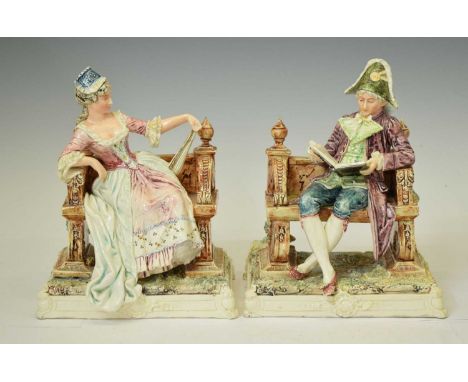 Pair of early 20th century Continental ceramic figures of 18th century gallant and companion, each modelled seated on bench, 
