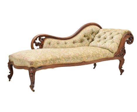 Victorian walnut deep button back chaise longue, upholstered in green floral fabric, raised on carved cabriole supports with 