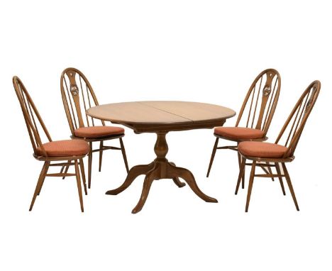 Ercol - Set of four Windsor swan-back dining chairs, together with an extending dining table with baluster pedestal raised on