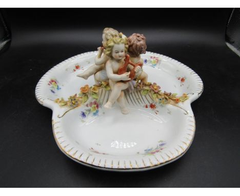 Meissen German cherub nut dish decorated with encrusted flowers with crossed swords and R marked on the base, In good conditi