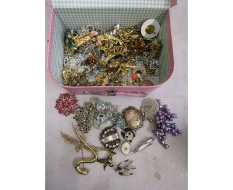 Vintage brooches in pink suitcase box