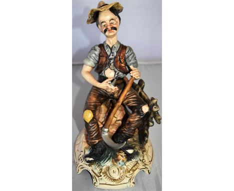 Capo di Monte figure - man sitting with garden tools H 30cm x W 18cm x D 23cm