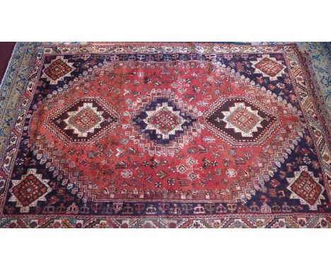 A fine South West Persian Qashqai carpet, triple chain medallion surrounded by stylised floral on terracotta filed repeat ivo