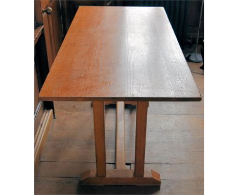 A light oak dining table with trestle base, H 77cm x W 137cm x D 67.5cm