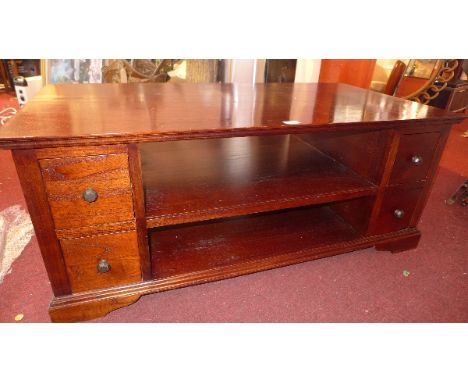 A contemporary mahogany coffee table with an arrangement of eight drawers and shelf space. H-50cm, W-123cm, D-63cm  