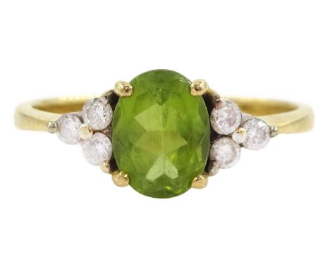 18ct gold oval cut peridot and six stone round brilliant cut diamond ring, stamped 750Condition Report: Approx 3.65gm, size R