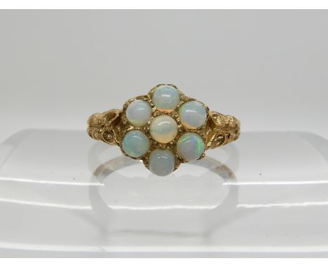 A 9ct gold opal flower cluster, size M1/2, weight 2.5gms Condition Report: One claw on edge needs attention.