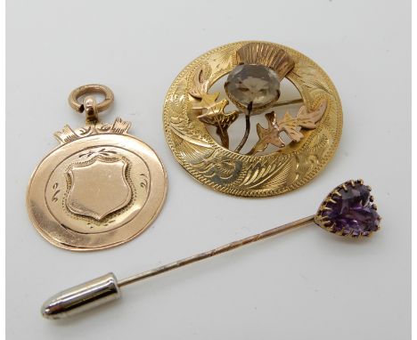 A 9ct gold Ward Brothers smoky quartz thistle brooch, a yellow metal heart shaped amethyst pin and a 9ct gold medallion, weig