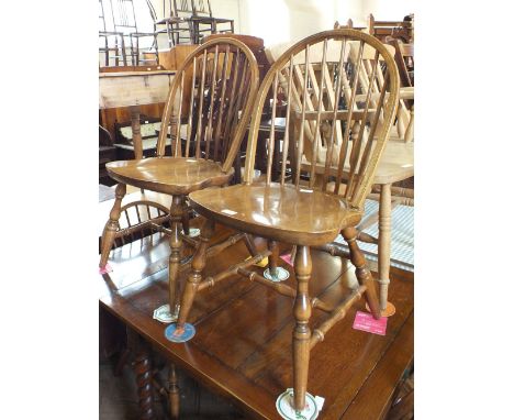 A set of four oak stick back kitchen chairs