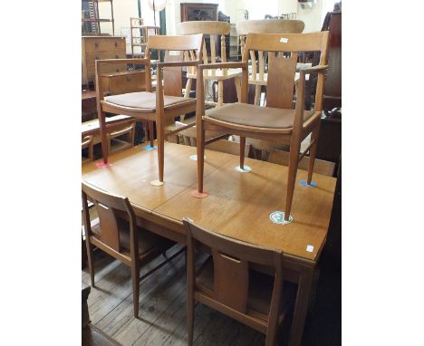 A light oak Nathan Furniture style dining table, four chairs and two carvers