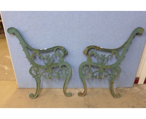 A pair of cast iron garden bench ends