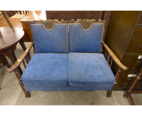 A 1930's oak and upholstered settle