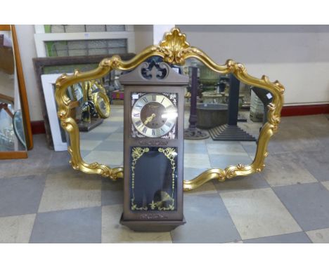 A gilt framed mirror and 31-day wall clock
