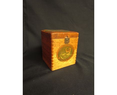 A wooden tea caddy with dyed detail