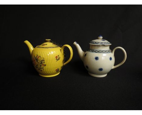 An early 19th Century bullet form blue and white teapot, some damage, with a yellow writhen form teapot with floral spray dec