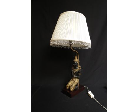 A decorative figural table lamp with droplet shade and cast metal Buddhist base.  70cm tall 