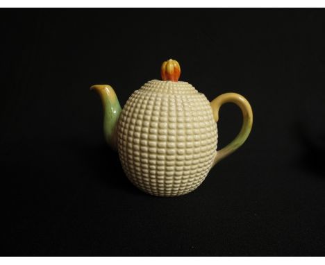 A Clarice Cliff Newport pottery teapot, fruit knop