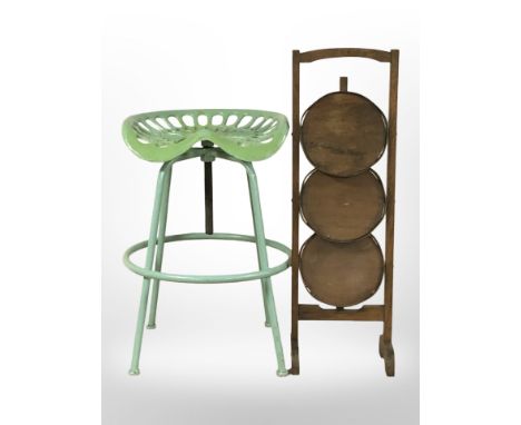 A tractor seat stool and an oak cake stand 