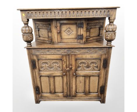 A reproduction carved oak buffet sideboard, 122 cm x 46 cm x 145 cm 