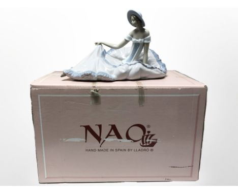 A Nao figure of a seated lady in large flowing dress, No. 1265, with original box. 
