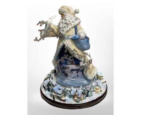 An Alice in Wonderland Bradford Exchange cuckoo clock and a Bradford Exchange Thomas Kinkade Christmas figure, both parts box