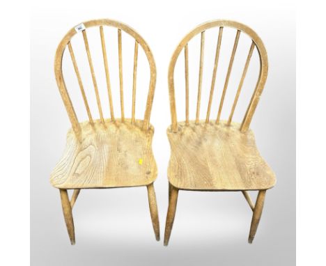 A pair of Ercol elm and beech spindle back dining chairs 