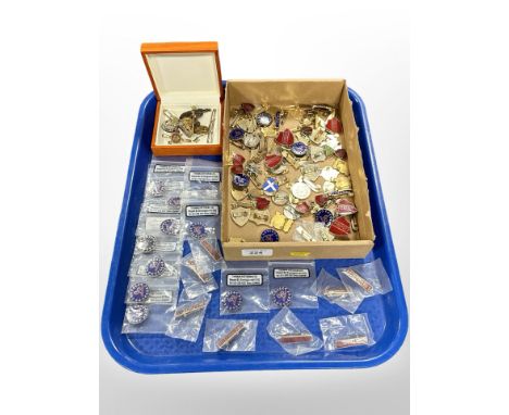 A collection of pins and lapel badges, including Army Service Corps, prefect badges, etc.