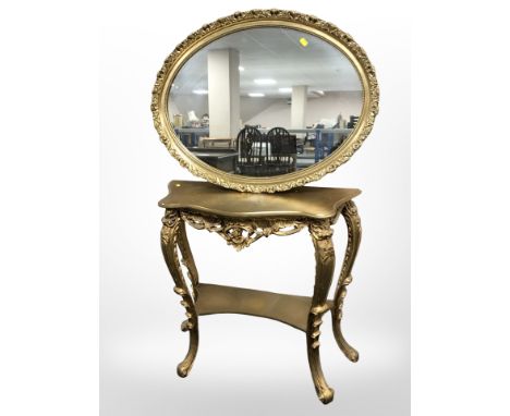 A reproduction gilt console table, width 75 cm and an oval mirror 