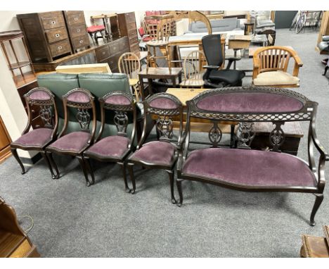 A reproduction carved mahogany two seater settee, width 109 cm and a set of four matching salon chairs in purple upholstery 