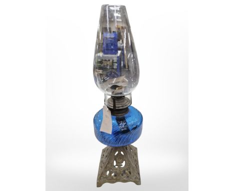An oil lamp with gilt metal base and blue glass reservoir, height 50 cm. 