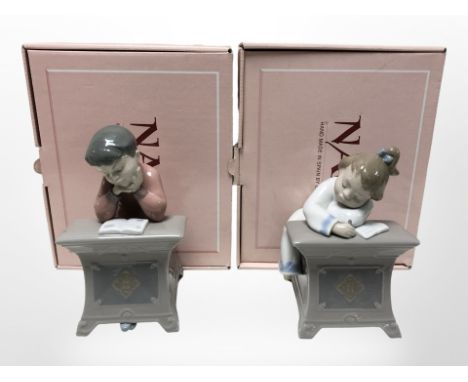 Two Nao figures of children studying, No. 1403 and 1404, both with original boxes. 