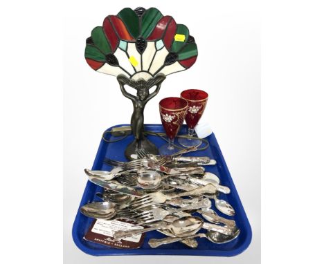 A brass and stained glass Tiffany-style table lamp, a pair of ruby glass wine glasses and a quantity of EPNS cutlery.