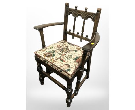 An Ercol stained elm armchair 
