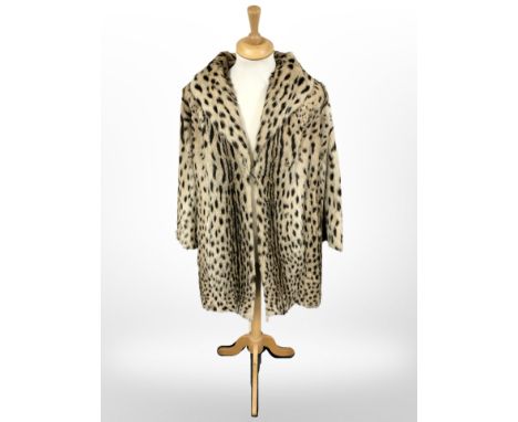 An early 20th century ocelot fur coat with mannequin  