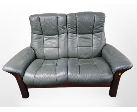 A contemporary stained wood framed two seater leather settee, width 151 cm 