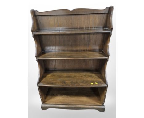 An Ercol stained elm waterfall open bookcase, 86 cm x 34 cm x 127 cm 
