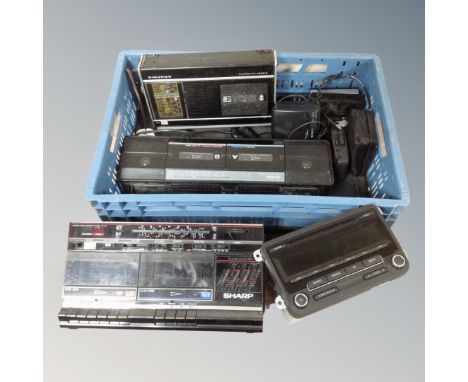 A crate containing radio cassette player, In-car CD player, Walkmans etc 