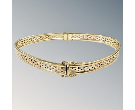 A 9ct gold three-tone gold bangle (misshapen)  CONDITION REPORT: 10g