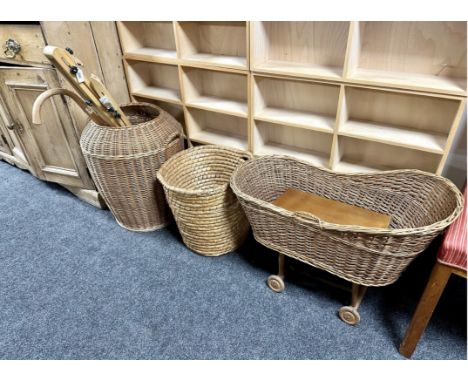 Two wicker baskets together with a wicker dolls crib on wheels, artist's box, stick etc 