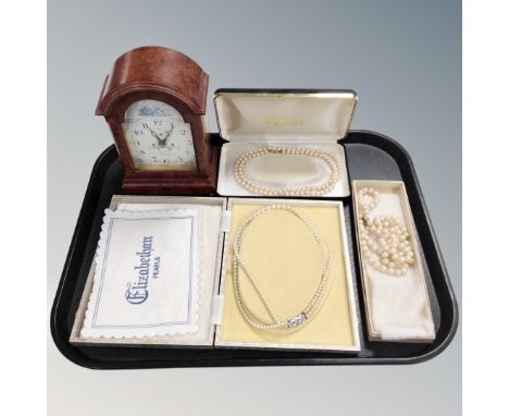 A tray of three boxed sets of costume pearls together with a contemporary mantel clock 