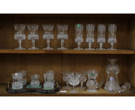 A part suite of Edinburgh Crystal thistle etched glass to include a decanter and stopper, small water jug, four tumblers, fou