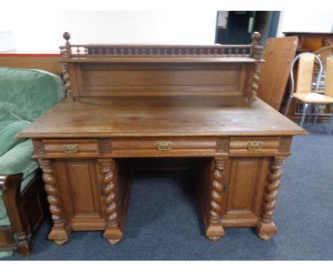 A 20th century oak twin pedestal writing desk fitted three drawers and back shelf 