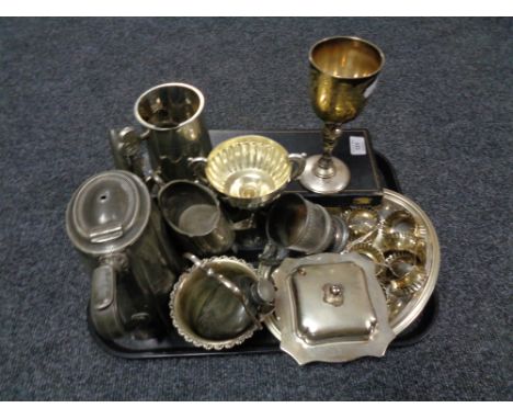 A tray of twentieth century plated wares, part tea service, napkin rings, goblet, cased servers, hip flask etc 