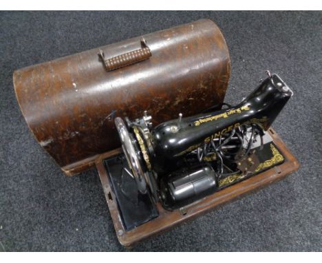A cased vintage Singer sewing machine (electric), two hand saws.