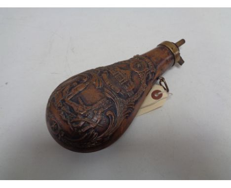 A reproduction brass and copper embossed black powder flask  CONDITION REPORT: Spring working. 