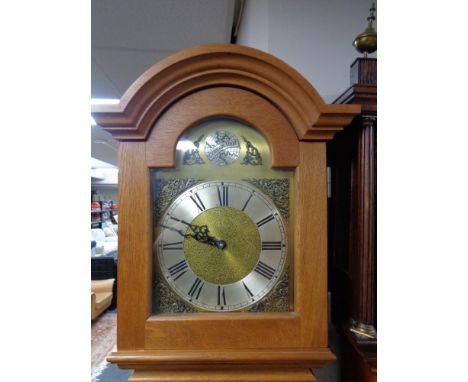 An oak cased longcase clock with pendulum and weights 