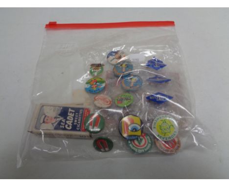 A collection of vintage pin badges and sweet cigarette cards 