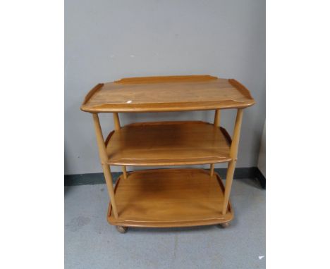 An Ercol elm three tier tea trolley 