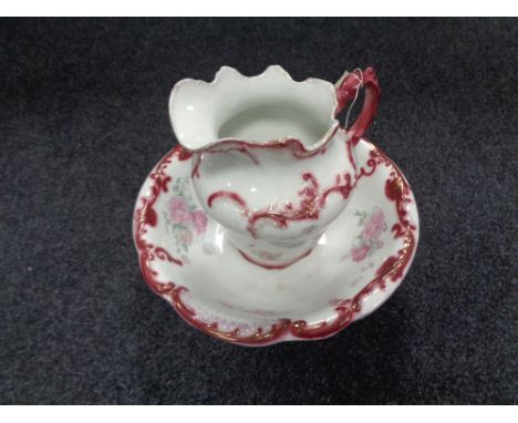 An antique floral wash jug and basin 